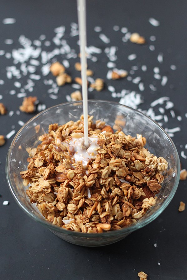 This coconut almond granola is easy to make, ready in under 30 minutes and full of delicious flavour. Plus, it's vegan, gluten free and refined sugar free via @ExSloth | ExSloth.com