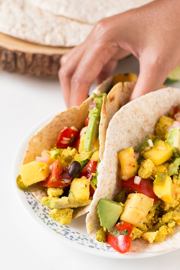 These vegan breakfast tacos are filling and flavourful, especially when topped with this super simple mango pineapple salsa via @ExSloth | ExSloth.com