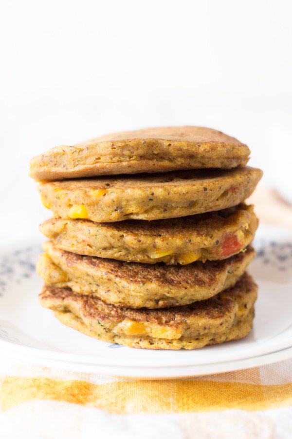 Zucchini Corn Savoury Pancakes (cornmeal pancakes) with spicy vegan sour cream. Perfect for breakfast, lunch and dinner. via @ExSLoth | ExSloth.com