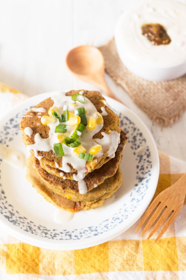 Zucchini Corn Savoury Pancakes (cornmeal pancakes) with spicy vegan sour cream. Perfect for breakfast, lunch and dinner. via @ExSLoth | ExSloth.com