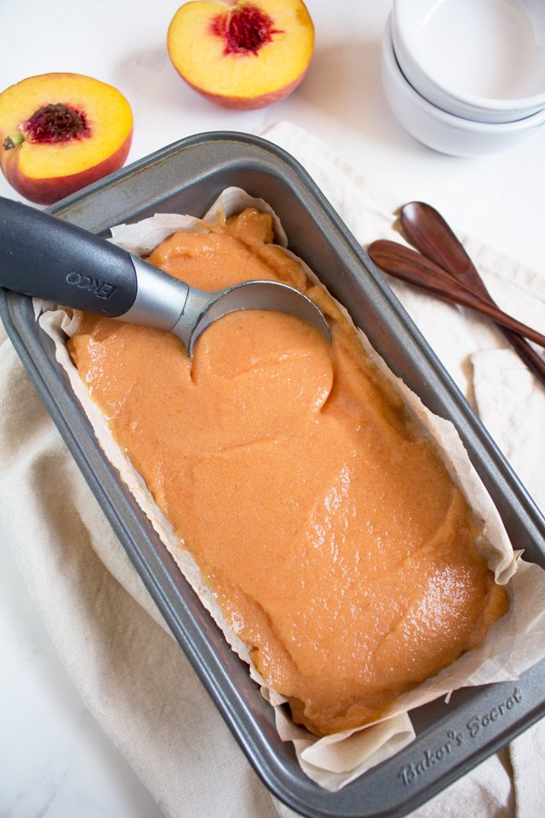 This creamy vegan peach rosé sorbet is perfectly sweet with a slight kick and doesn't require an ice cream maker via @ExSloth | ExSloth.com