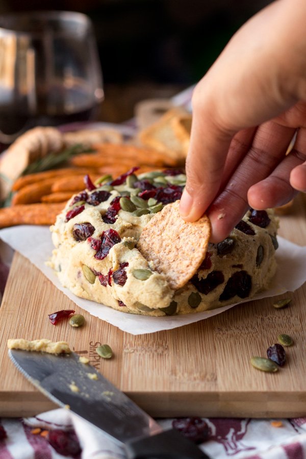 Vegan Lentil Cashew Cheese Ball - An easy vegan cheese recipe topped with cranberries and pumpkin seeds. Perfect for holiday or Christmas parties | ExSloth.com