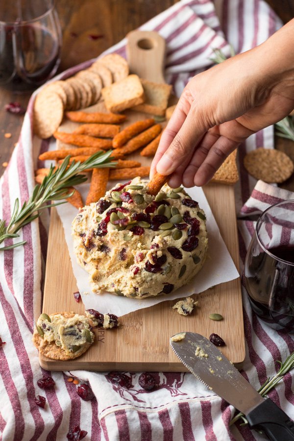 Vegan Lentil Cashew Cheese Ball - An easy vegan cheese recipe topped with cranberries and pumpkin seeds. Perfect for holiday or Christmas parties | ExSloth.com