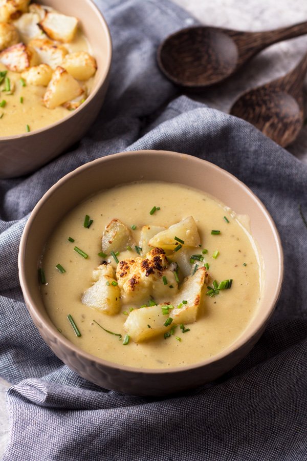 This cheesy vegan cauliflower soup is creamy, filling and bursting with flavour. It's also gluten-free, Whole30 approved and required just 1 hour and 10 ingredients. It's the perfect vegan soup for warming up on cold winter days | ExSloth.com