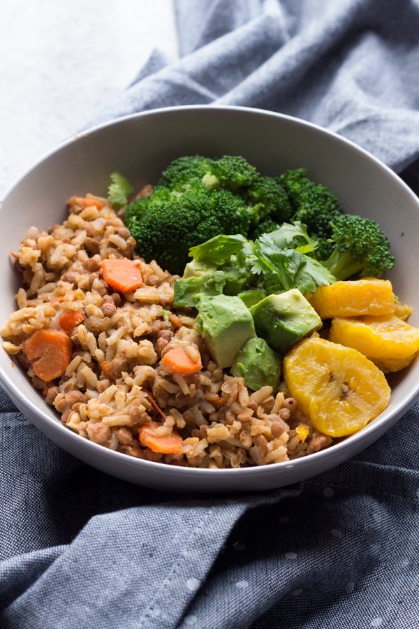This Trini-style slow cooker lentil rice bowl is filled with Trinidad inspired plant-based flavours and makes the perfect healthy vegan buddha bowl for lunch or dinner | ExSloth.com