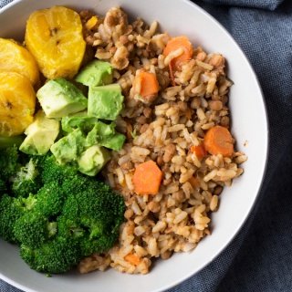 This Trini-style lentils and rice bowl is filled with tonnes of Caribbean inspired plant-based flavours and makes the perfect healthy vegan buddha bowl for lunch or dinner | ExSloth.com