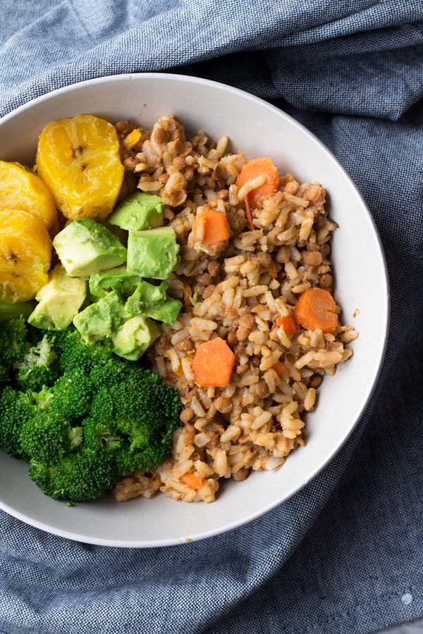 This Trini-style slow cooker lentil rice bowl is filled with Trinidad inspired plant-based flavours and makes the perfect healthy vegan buddha bowl for lunch or dinner | ExSloth.com
