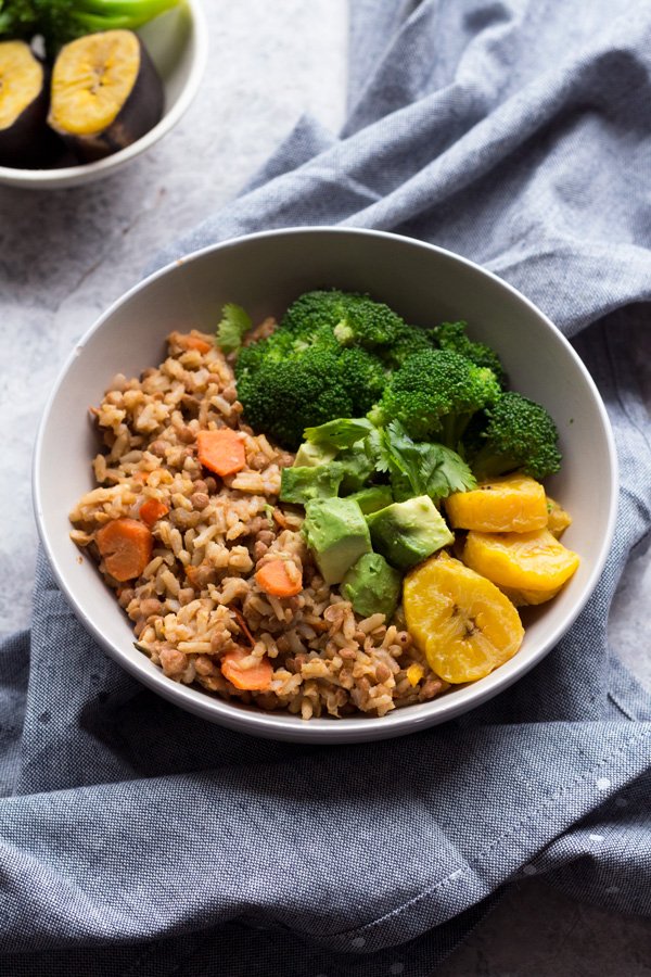 This Trini-style slow cooker lentil rice bowl is filled with Trinidad inspired plant-based flavours and makes the perfect healthy vegan buddha bowl for lunch or dinner | ExSloth.com