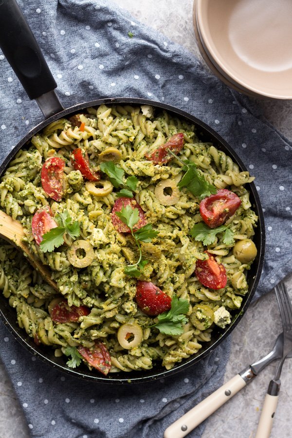 This easy vegan cilantro pesto pasta is flavourful, spicy, filling and calls for just 10 ingredients and about 25 minutes. Perfect vegan lunch or dinner | ExSloth.com
