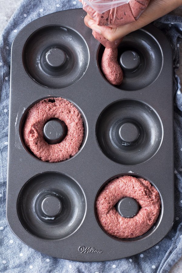 These vegan red velvet donuts are a delicious, healthy alternative to regular fried donuts and are great for Valentine's Day. The vegan cashew cream cheese frosting is also easy to make, creamy and perfectly sweet | ExSloth.com