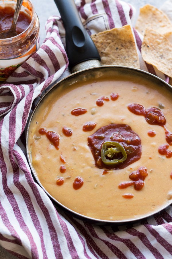 This nut-free vegan queso dip is made with potatoes instead of cashews but is just as creamy and flavourful | ExSloth.com