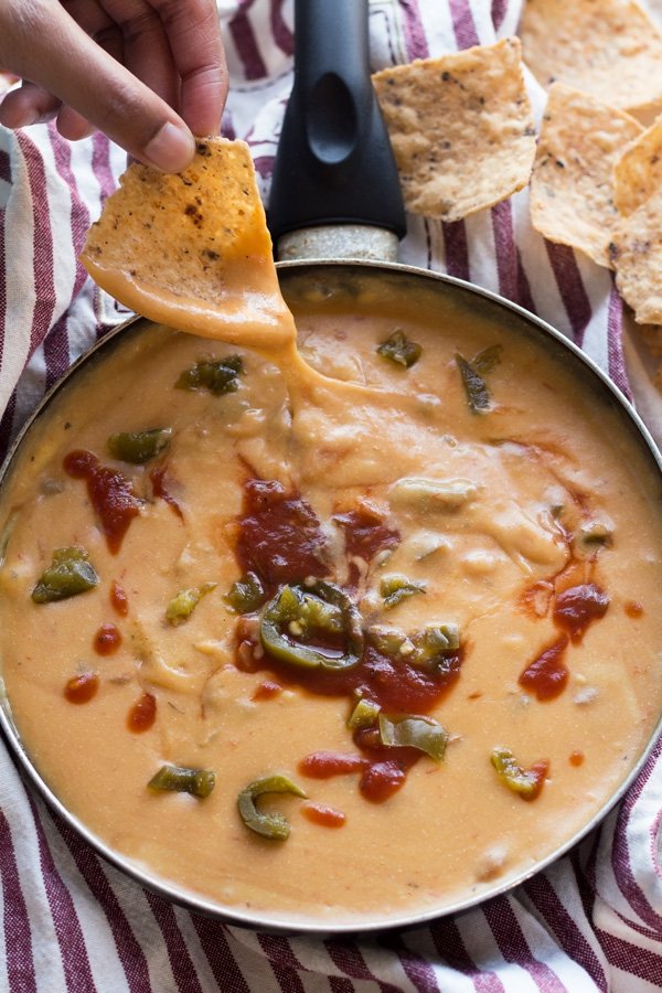 This nut-free vegan queso dip is made with potatoes instead of cashews but is just as creamy and flavourful | ExSloth.com