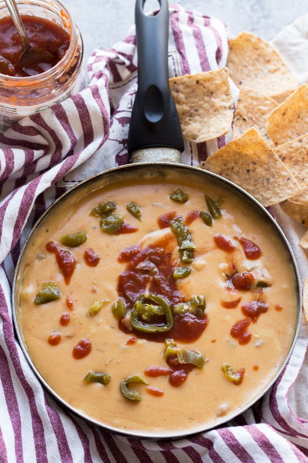 This nut-free vegan queso dip is made with potatoes instead of cashews but is just as creamy and flavourful | ExSloth.com